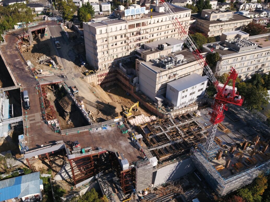 既存棟の解体と新病棟の建設が並行して進む工事現場の様子